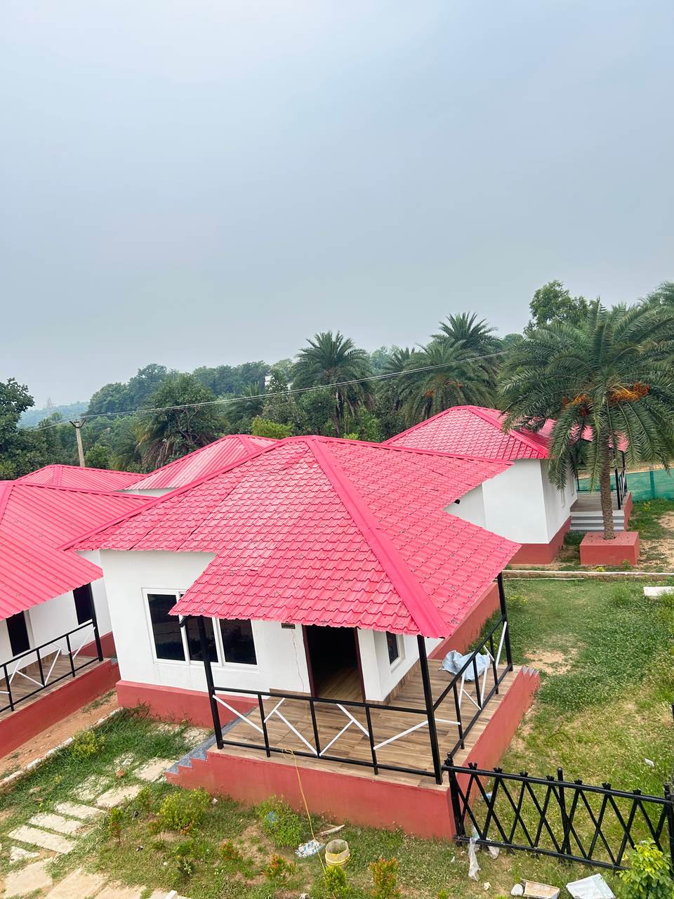 Cottage exterior with white walls and red tile roof at Chamtaburu Eco Village, Ajodhya Hills, Purulia